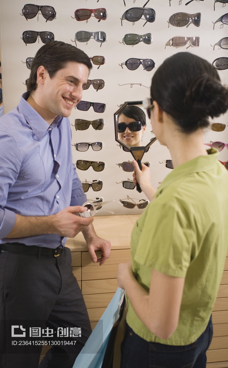 Woman trying on sunglasses in store